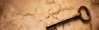 An antique key resting on parchment